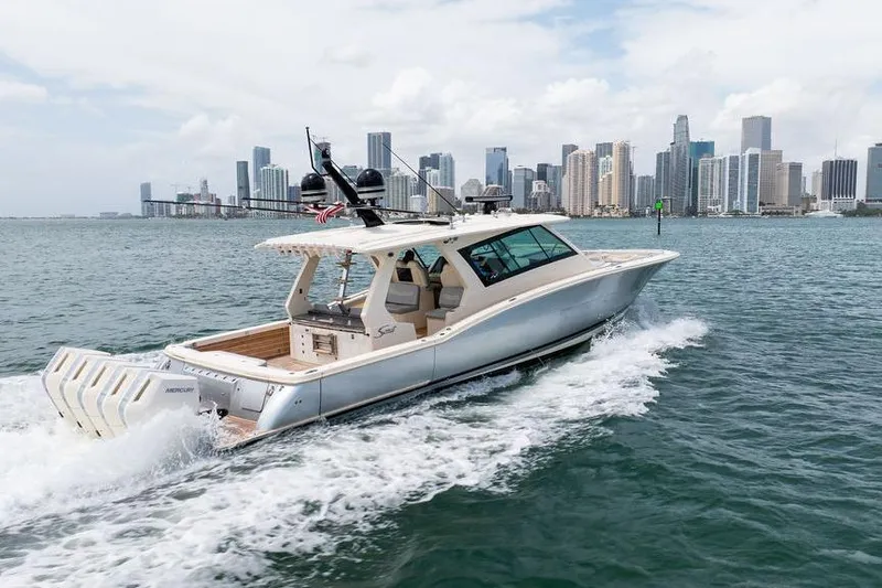 Slide: The Image of Scout 530 LXF 2020 yacht cruising near city skyline on water. - 39