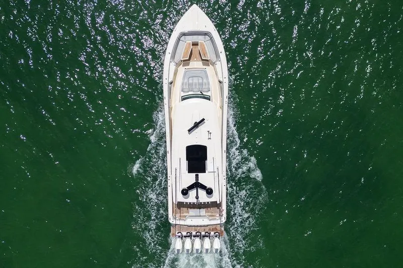 Slide: The Image of Aerial view of 2020 Scout 530 LXF yacht cruising on green water. - 4
