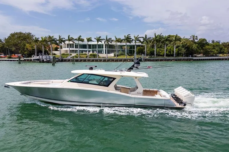 Slide: The Image of 2020 Scout 530 LXF luxury boat cruising on a scenic waterway. - 41