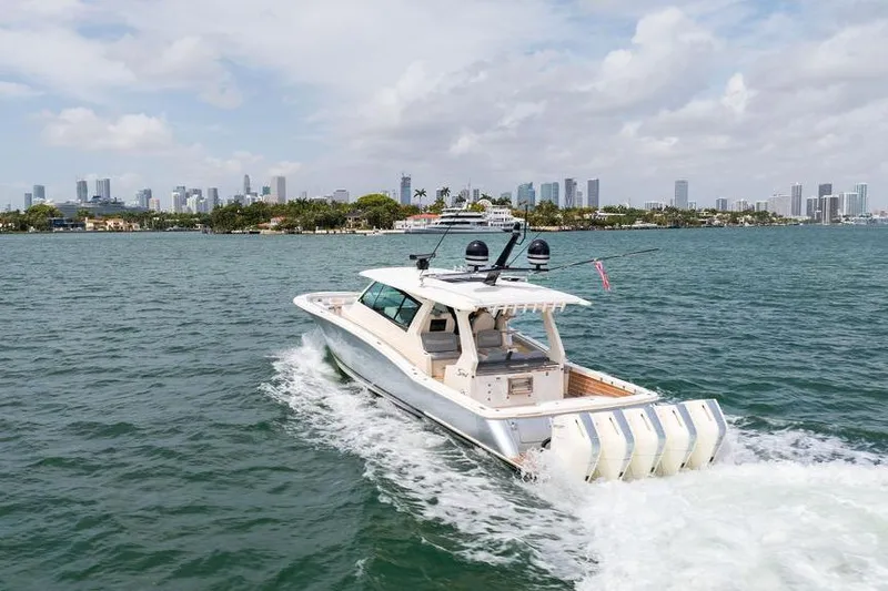 Slide: The Image of 2020 Scout 530 LXF cruising on water with city skyline in background. - 5
