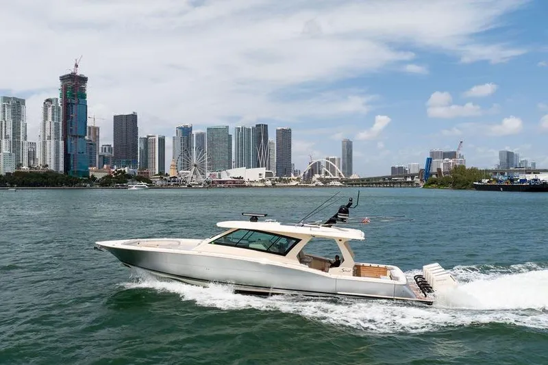 Slide: The Image of 2020 Scout 530 LXF yacht cruising near a city skyline on a sunny day. - 50