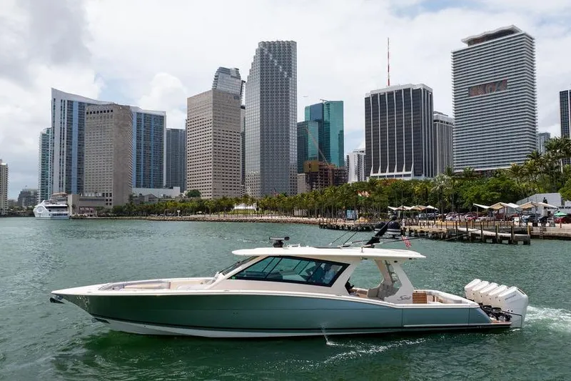 Slide: The Image of 2020 Scout 530 LXF yacht cruising near city skyline. - 52