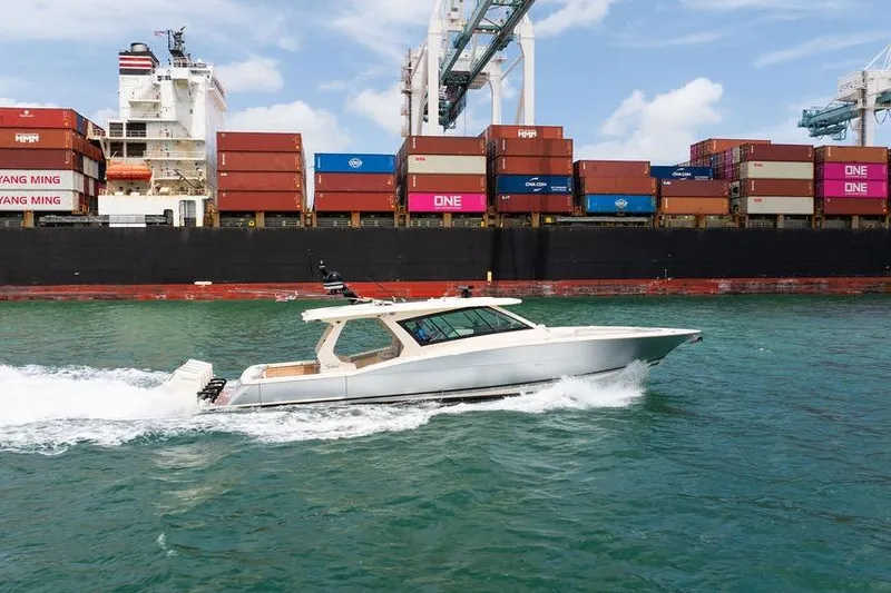 Slide: The Image of 2020 Scout 530 LXF cruising near a large container ship in a busy port. - 54