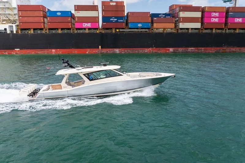 Slide: The Image of 2020 Scout 530 LXF yacht cruising near a container ship in open water. - 55