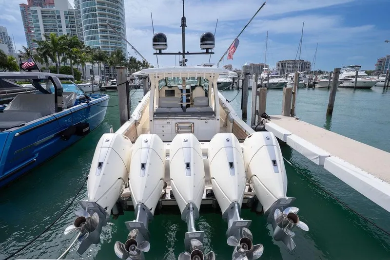 Slide: The Image of 2020 Scout 530 LXF boat docked with four powerful outboard engines. - 56