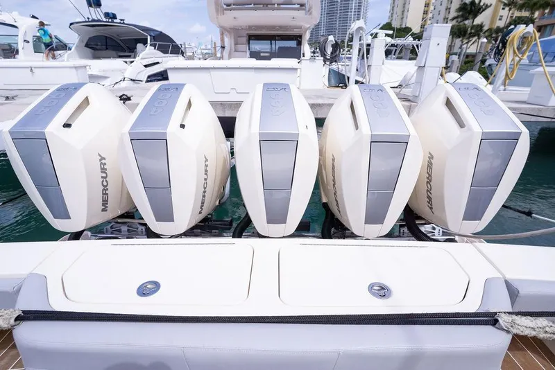 Slide: The Image of Five Mercury outboard engines on a 2020 Scout 530 LXF boat at a marina. - 58