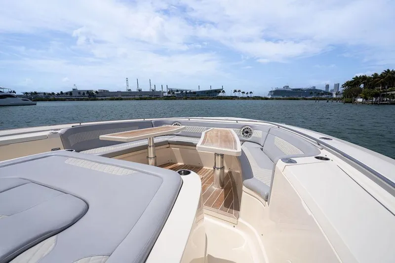 Slide: The Image of Luxurious 2020 Scout 530 LXF boat interior with seating and table on calm water. - 59