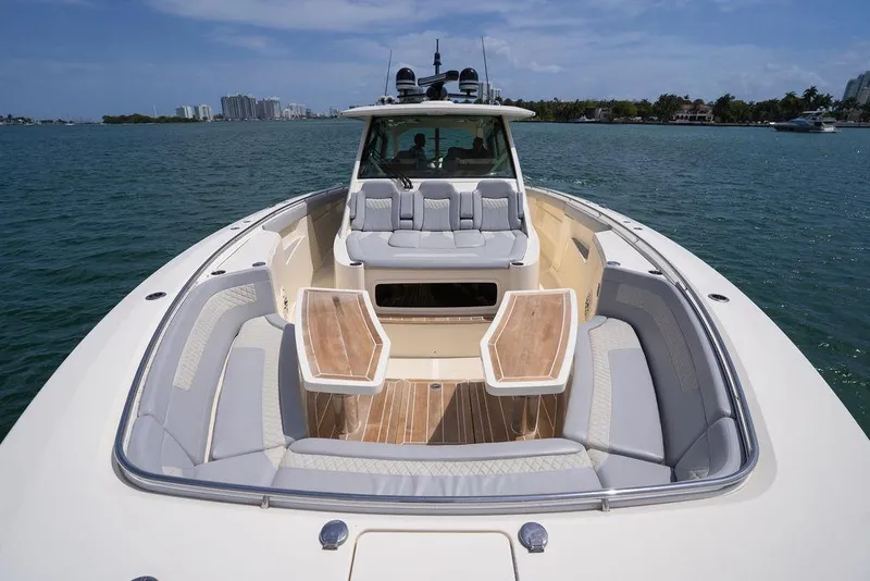 Slide: The Image of 2020 Scout 530 LXF luxury boat with spacious seating on calm water. - 62