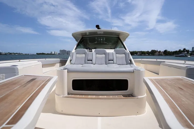 Slide: The Image of 2020 Scout 530 LXF luxury boat interior with plush seating and wooden accents. - 63