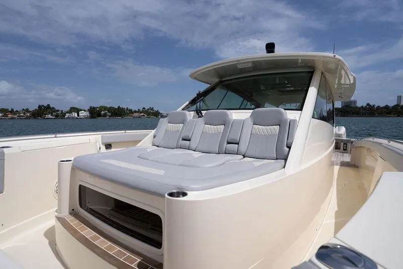 Slide: The Image of 2020 Scout 530 LXF luxury boat with plush seating, cruising on a sunny day. - 64