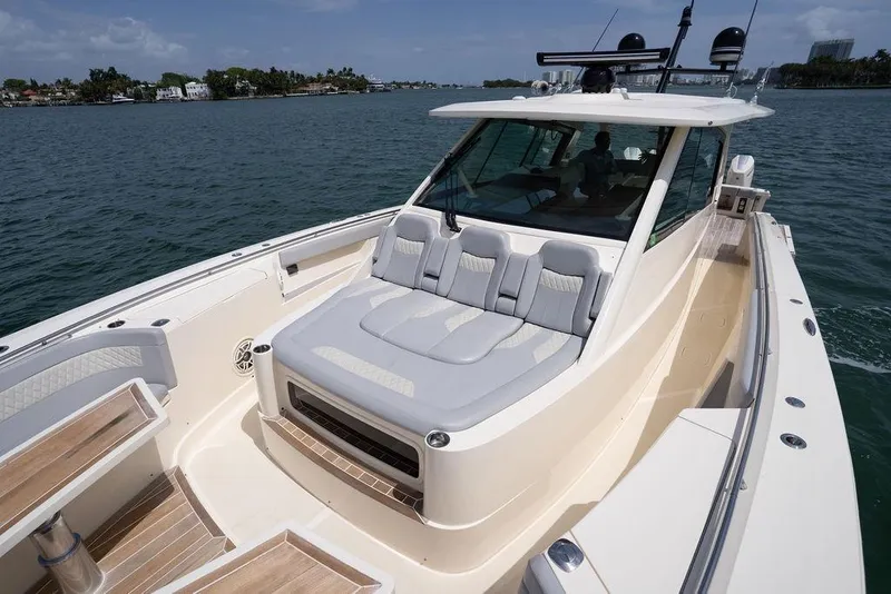 Slide: The Image of 2020 Scout 530 LXF luxury boat with spacious seating on calm waters. - 65
