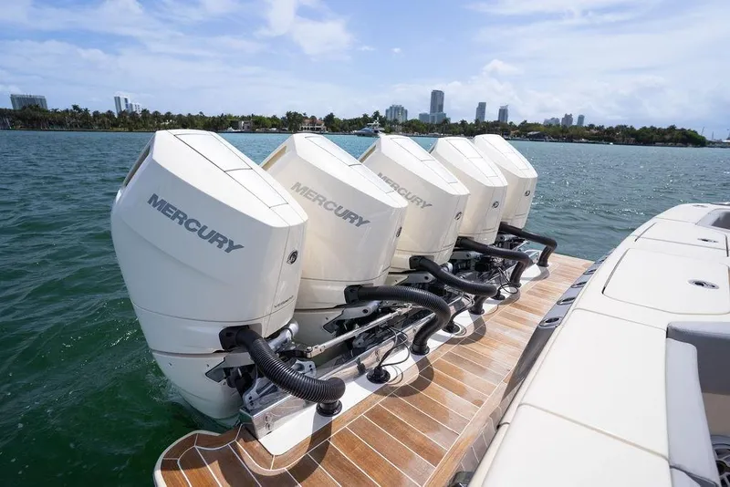 Slide: The Image of Four Mercury outboard engines on a 2020 Scout 530 LXF boat, docked on water. - 71