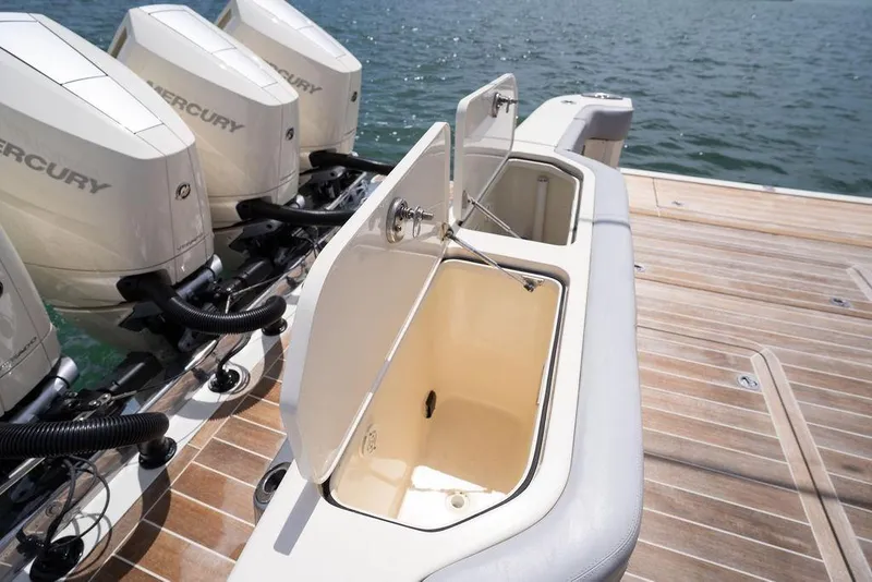 Slide: The Image of 2020 Scout 530 LXF boat with open storage compartments and Mercury outboard engines. - 73