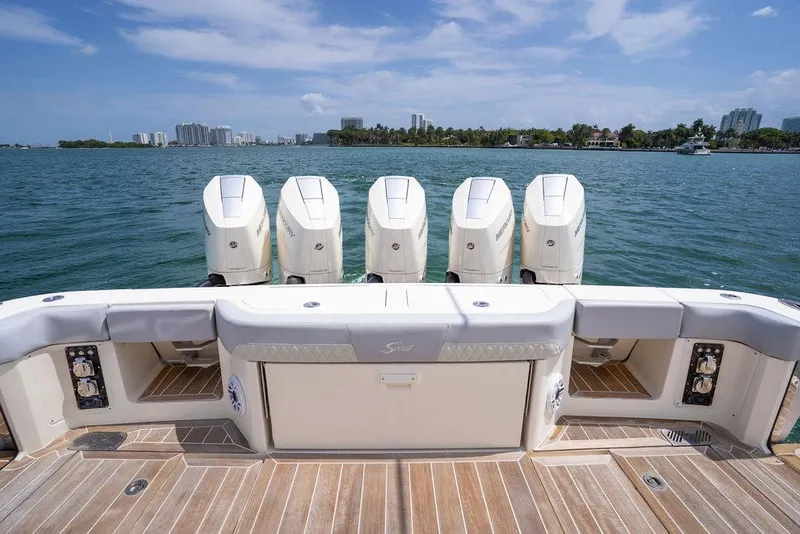 Slide: The Image of 2020 Scout 530 LXF boat with five powerful outboard engines on a sunny day. - 74