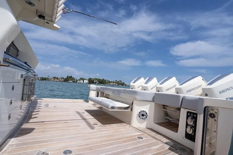 Slide: The Image of 2020 Scout 530 LXF yacht deck with Mercury engines, under a clear blue sky. - 77