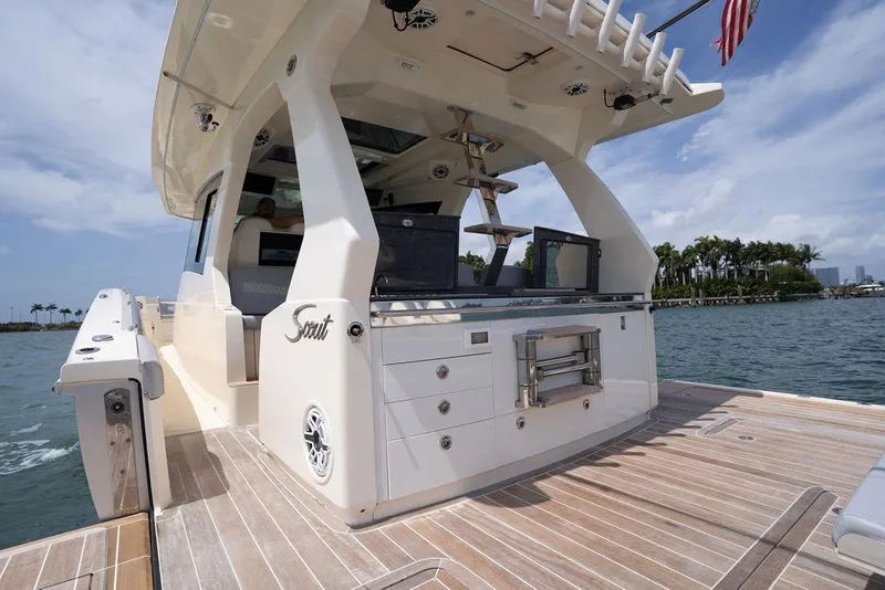 Slide: The Image of 2020 Scout 530 LXF luxury yacht with sleek design, docked near palm trees. - 78