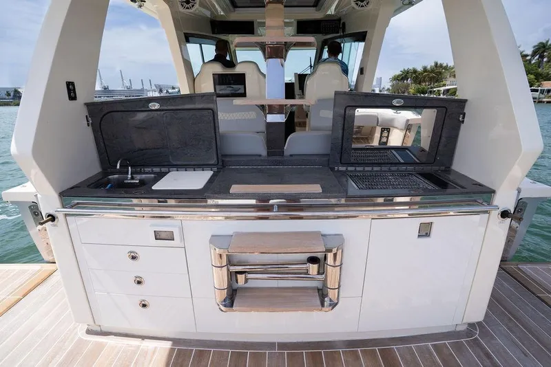 Slide: The Image of Luxury outdoor kitchen on 2020 Scout 530 LXF yacht, featuring grill and sink. - 81
