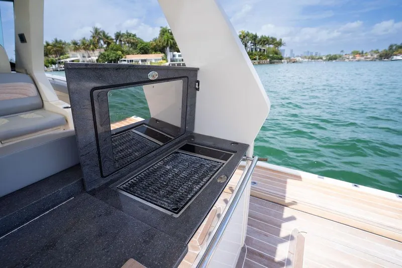Slide: The Image of 2020 Scout 530 LXF yacht with open grill, overlooking serene waters. - 83