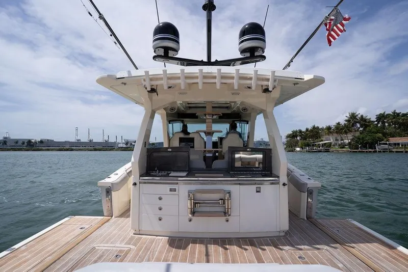 Slide: The Image of 2020 Scout 530 LXF luxury boat on water, featuring spacious deck and modern amenities. - 84