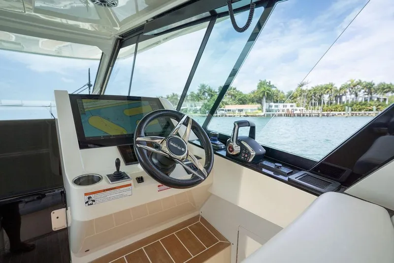 Slide: The Image of Helm of 2020 Scout 530 LXF yacht with navigation screen and steering wheel. - 93