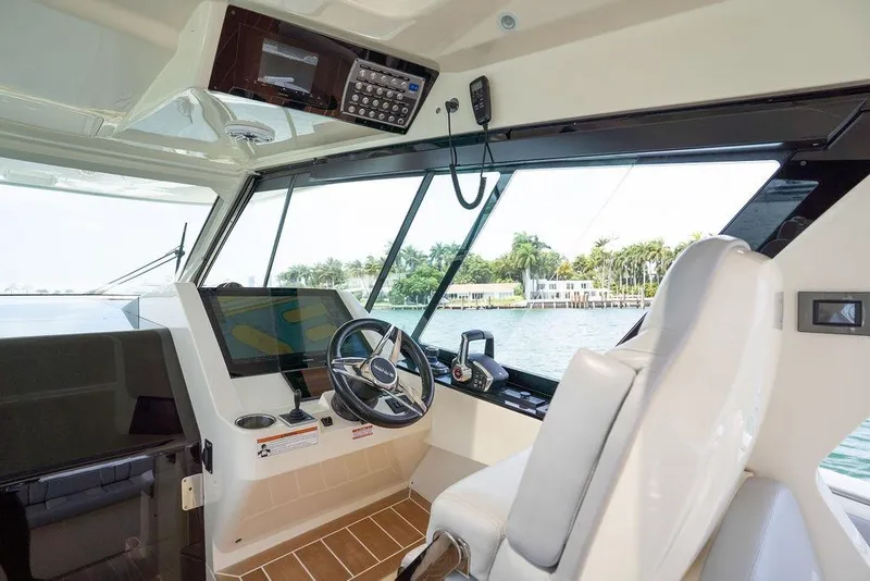 Slide: The Image of 2020 Scout 530 LXF boat cockpit with modern navigation equipment and waterfront view. - 94
