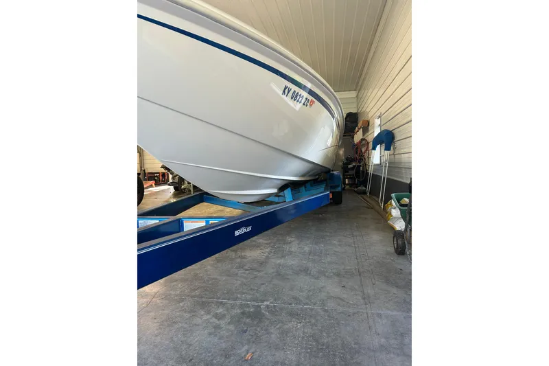 Slide: The Image of 2004 Sunsation 32 Dominator boat on trailer in garage storage. - 10