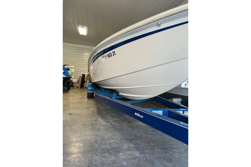Slide: The Image of 2004 Sunsation 32 Dominator boat on blue trailer in garage. - 11