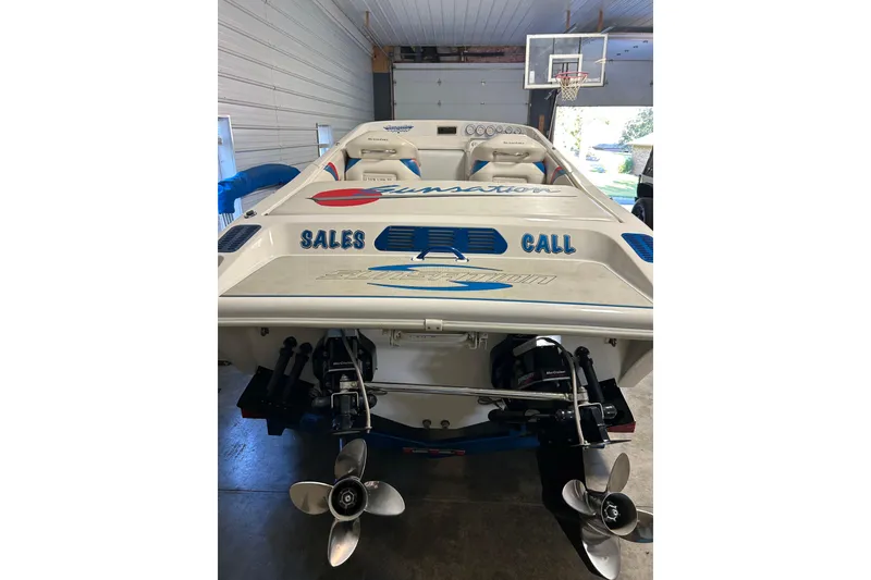 Slide: The Image of 2004 Sunsation 32 Dominator boat in garage, showcasing dual propellers and sporty design. - 13