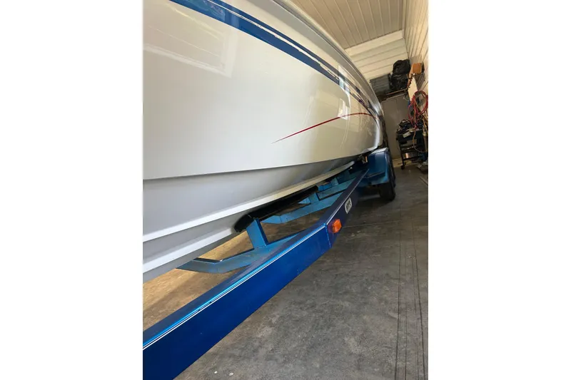 Slide: The Image of 2004 Sunsation 32 Dominator boat on blue trailer in storage. - 16