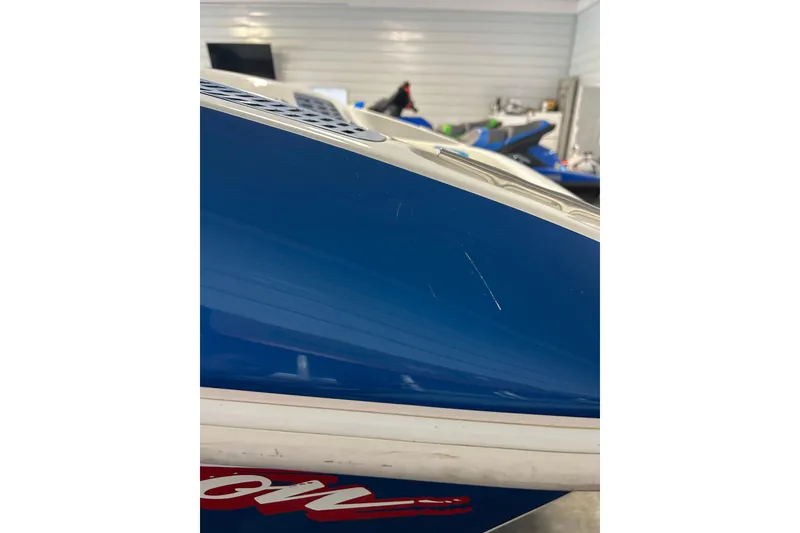 Slide: The Image of 2004 Sunsation 32 Dominator boat with blue and white exterior, showing minor scratches. - 17