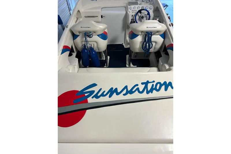 Slide: The Image of 2004 Sunsation 32 Dominator boat interior with branded seating and dashboard. - 21