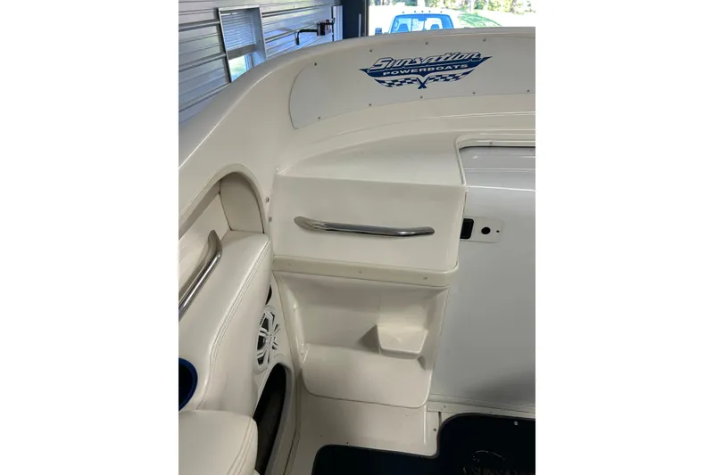Slide: The Image of 2004 Sunsation 32 Dominator boat interior with white seating and logo. - 24