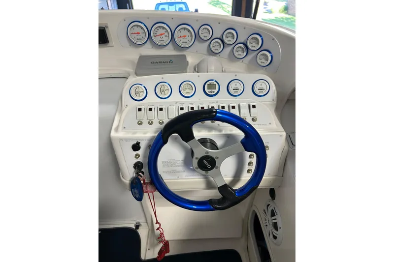 Slide: The Image of 2004 Sunsation 32 Dominator dashboard with blue steering wheel and multiple gauges. - 25