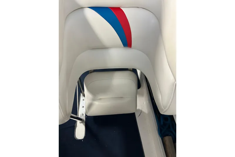 Slide: The Image of 2004 Sunsation 32 Dominator boat interior with white upholstery and red-blue accents. - 26
