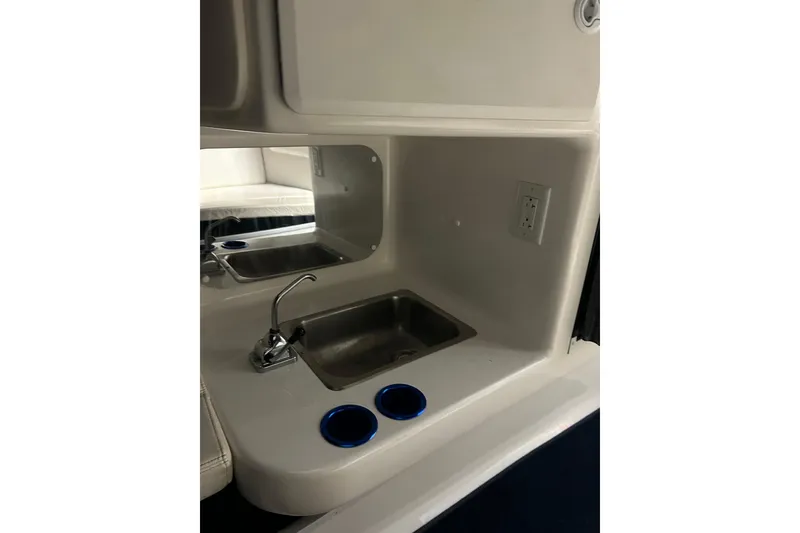 Slide: The Image of 2004 Sunsation 32 Dominator boat interior with sink and cup holders. - 27
