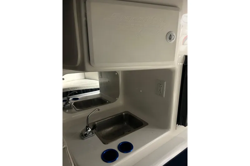 Slide: The Image of 2004 Sunsation 32 Dominator boat interior with sink and storage area. - 28