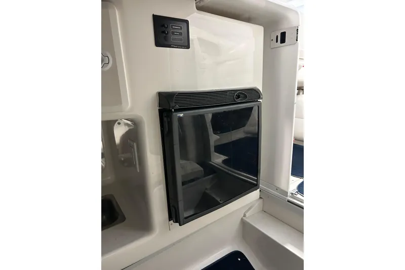 Slide: The Image of 2004 Sunsation 32 Dominator interior with built-in mini fridge and control panel. - 29