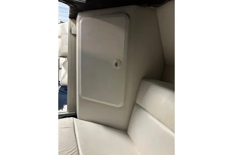 Slide: The Image of 2004 Sunsation 32 Dominator interior cabin with white seating and storage compartment. - 30