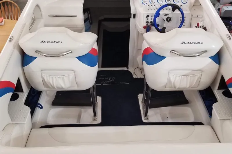 Slide: The Image of 2004 Sunsation 32 Dominator boat interior with white and blue seating and steering wheel. - 33