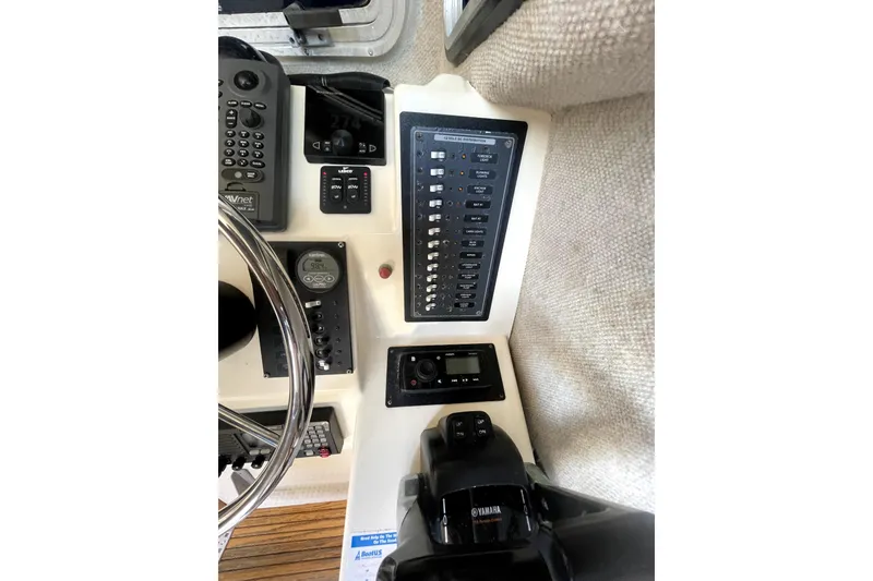 Slide: The Image of Control panel of a 2006 Parker 2520 SL Sport Cabin boat with various instruments and switches. - 11