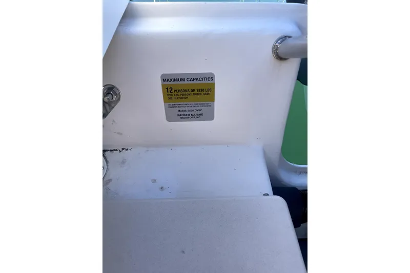 Slide: The Image of Capacity label on 2006 Parker 2520 SL Sport Cabin boat, indicating 12-person limit. - 24