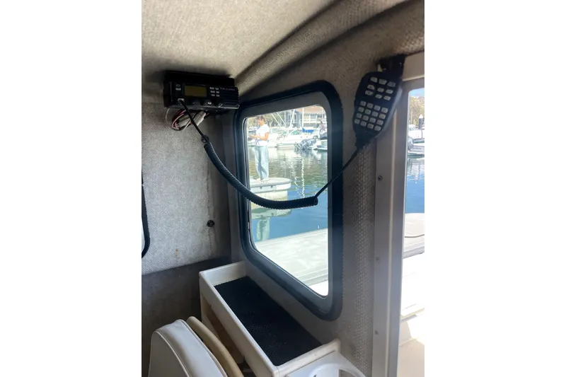 Slide: The Image of Interior of a 2006 Parker 2520 SL Sport Cabin with radio equipment and window view. - 27