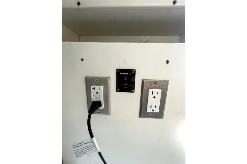 Slide: The Image of Electrical outlets and control panel inside a 2006 Parker 2520 SL Sport Cabin boat. - 29
