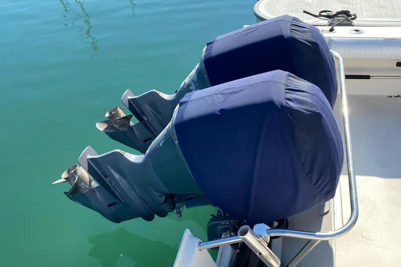 Slide: The Image of Twin outboard motors with blue covers on a 2006 Parker 2520 SL Sport Cabin boat. - 3