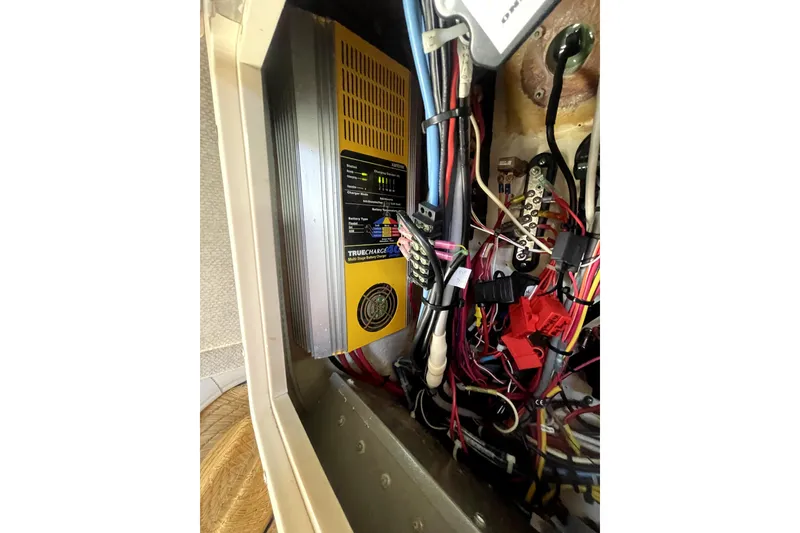 Slide: The Image of Electrical wiring and charger inside a 2006 Parker 2520 SL Sport Cabin boat. - 9