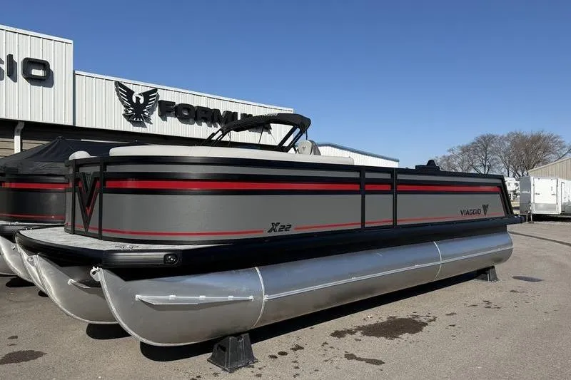 The Image of 2026 Viaggio X22D pontoon boat with sleek design, parked outdoors. - 0