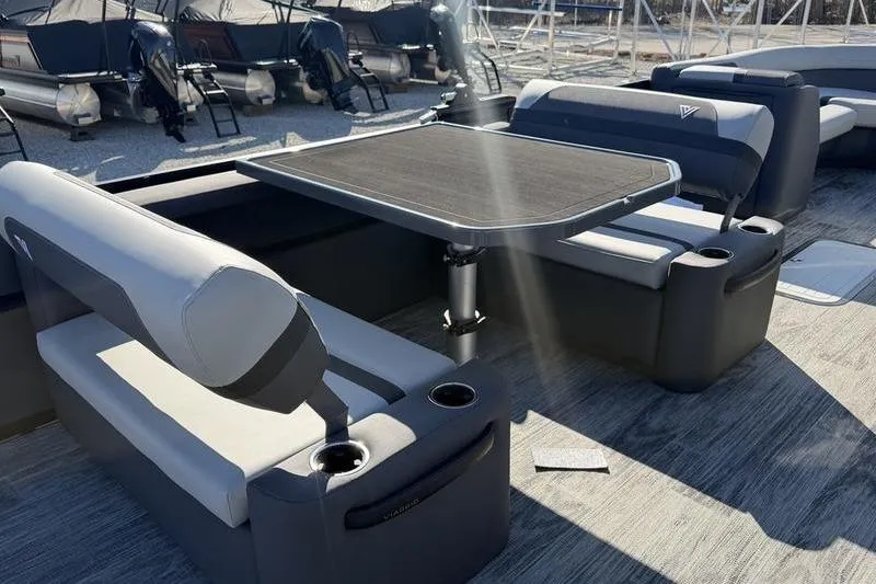Slide: The Image of Luxurious seating area on 2026 Viaggio X22D pontoon boat with table and cup holders. - 7