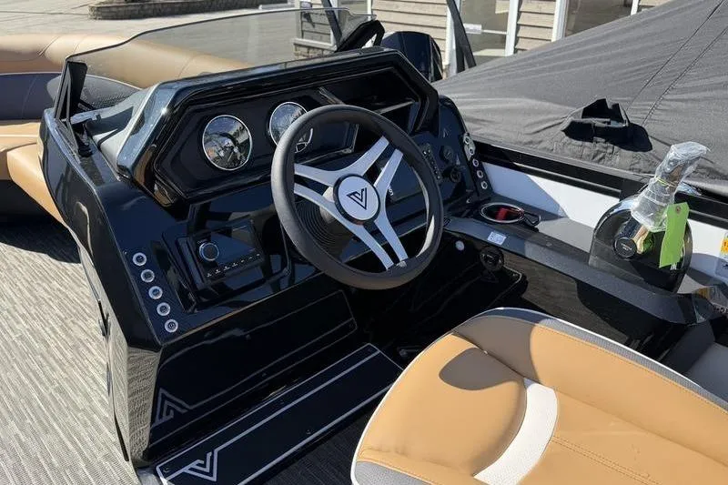 Slide: The Image of Steering console of 2026 Viaggio x22u boat with modern controls and tan seating. - 6