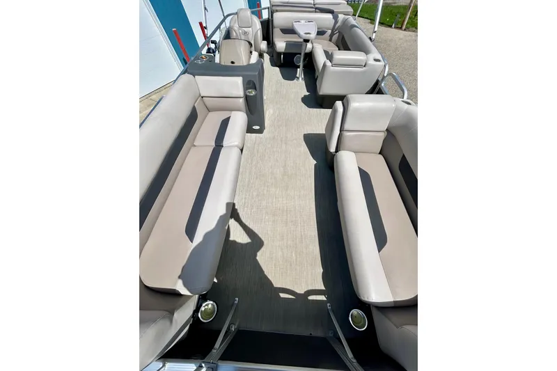 Slide: The Image of 2019 Princecraft Vectra 21 pontoon boat interior with beige seating and spacious layout. - 22