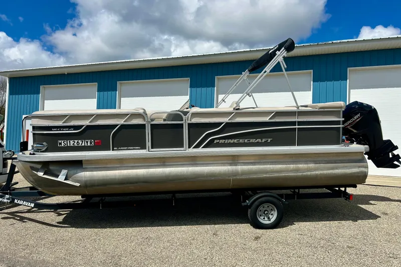 Slide: The Image of 2019 Princecraft Vectra 21 pontoon boat on trailer, parked outside blue building. - 3